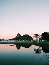 Scenic view of lake against sky at sunset