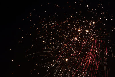 Low angle view of firework display at night