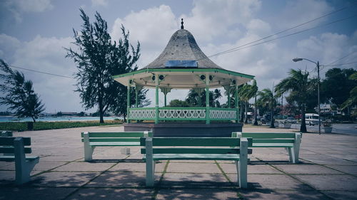 Gazebo by trees against sky