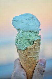 Human hand holding ice cream cone