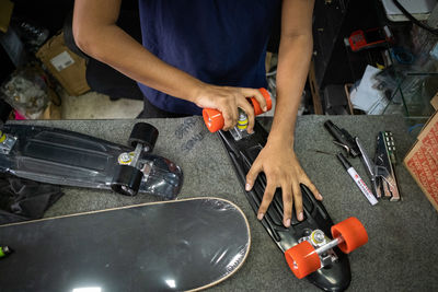 Midsection of man working in workshop