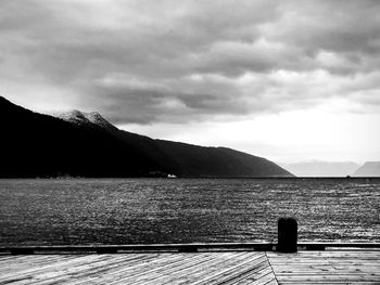 Pier over lake against sky