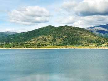 Scenic view of sea and mountains against sky