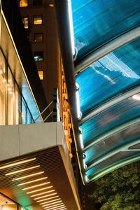 Low angle view of illuminated modern building at night