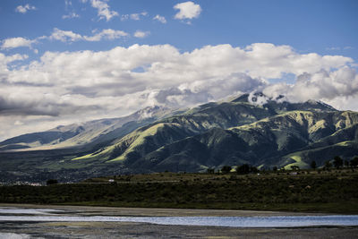 Scenic view of lake and mountains against sky