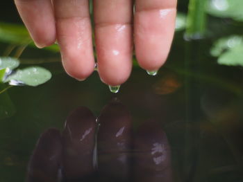 Midsection of person against blurred water