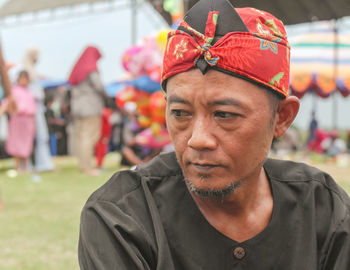 Portrait of a man wearing a traditional headband at a traditional event