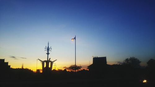 Low angle view of silhouette street light against sky at sunset