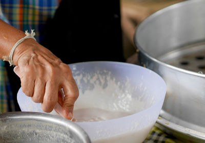 Close-up of man preparing food in kitchen