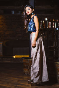 Portrait of beautiful young woman standing at home