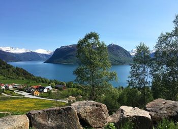 Scenic view of lake against clear blue sky