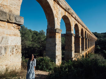 Woman standing in front of historical building