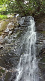 Scenic view of waterfall against sky