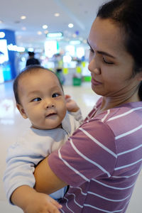 Baby boy with mother suffering from cross-eyed