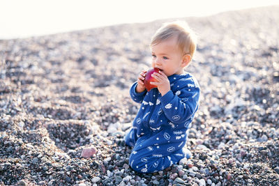 Cute girl on pebbles