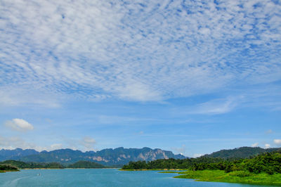 Scenic view of sea and mountains against sky