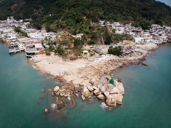 High angle view of trees and buildings by sea