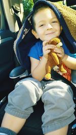 Portrait of smiling boy sitting in bus