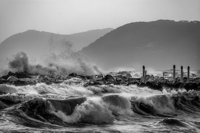 Water splashing in sea against sky