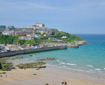 Scenic view of sea and buildings against sky