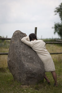 Rear view of woman standing against sky