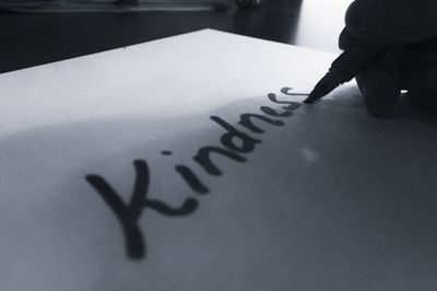 Close-up of human hand on paper