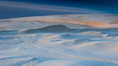 Aerial view of desert against sky during winter