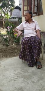 Rear view of woman with pink flowers in garden
