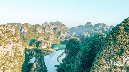 Panoramic view of rocks and mountains against clear sky