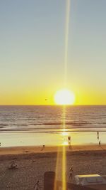 Scenic view of sea against clear sky during sunset