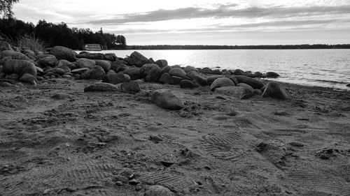 Pebbles on beach against sky