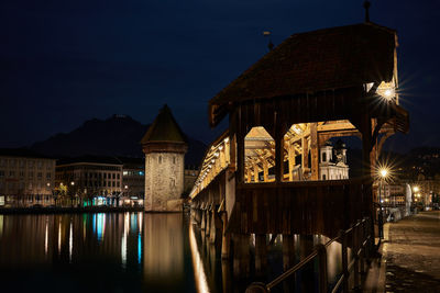 Illuminated city against sky at night