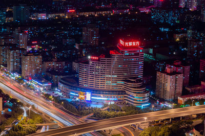 High angle view of illuminated city street and buildings at night