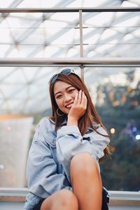 Portrait of beautiful young woman sitting in car