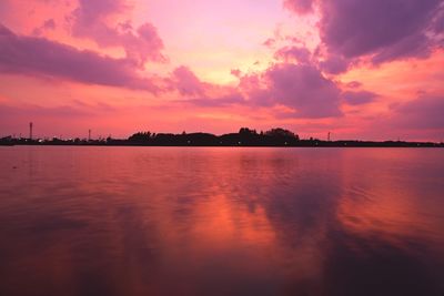 Scenic view of lake against romantic sky at sunset