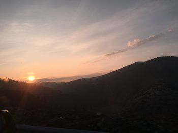 Scenic view of silhouette mountains against sky during sunset