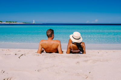 Full length of men on beach against sky