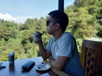 Young man drinking coffee from cup