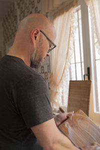 Side view of man working in kitchen at home