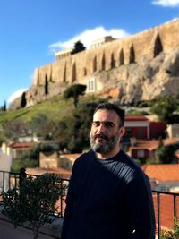 Portrait of man standing against castle