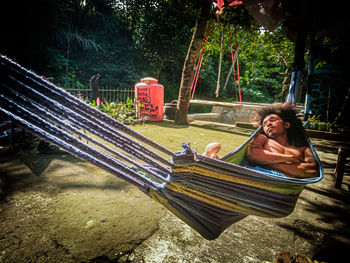 Full length of man relaxing on hammock