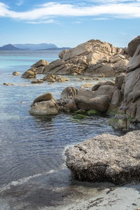 Rocks on beach against sky