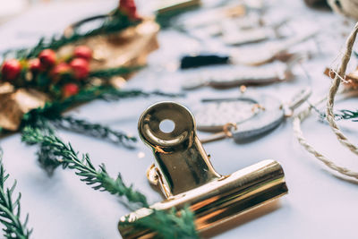 Close-up of binder clip by christmas decorations on table