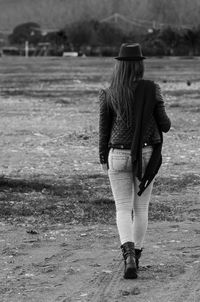Rear view of woman standing in park