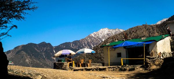 Scenic view of mountains against clear blue sky