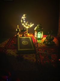 Close-up of illuminated lighting equipment on table