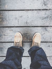 Low section of man standing on tiled floor