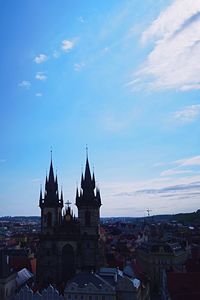 View of cityscape against blue sky