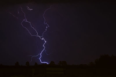 Low angle view of lightning in sky at night