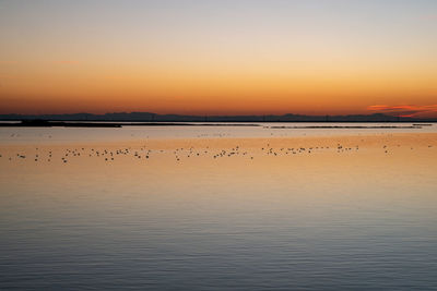 Scenic view of lake against sky during sunset